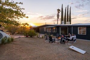 A residential area with a house, outdoor seating, and a fire pit. - Bed N` Burke | Pool + Spa | Peloton | Fire Pit (Yucca Valley)