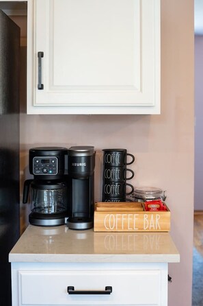 A kitchenette with a coffee maker, a Keurig, and a coffee bar sign. - Lake Front! Hot Tub, Fire Pits, Game Room (East Stroudsburg)