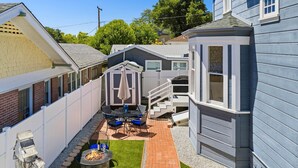 A residential backyard with a patio, a small shed, and a fire pit. - Blue Chestnut-Westside Paso Getaway (Paso Robles)