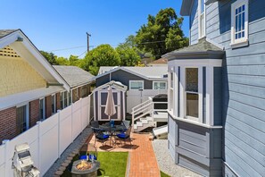 A residential backyard with a patio, a small shed, and a fire pit. - Blue Chestnut-Westside Paso Getaway (Paso Robles)