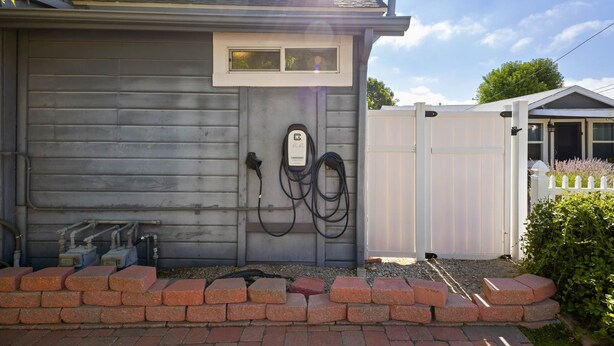 A garage with a power outlet and a cable connected to a device. - Blue Chestnut-Westside Paso Getaway (Paso Robles)