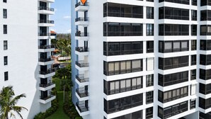 A multi-story hotel with balconies and a central location marker. - Punta Rassa Luxe Waterfront w/ Panoramic Views, Gorgeous Sunsets, Pool, Hot Tub (Fort Myers)