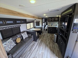 Living area - Jupiter Camper Suite - Family planet camper with bunk beds, sleeps six (Penrose)