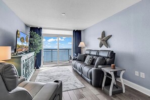 A living room with a sofa, armchairs, a small table, a starfish decoration, and a view of the ocean. - Unobstructed Oceanfront View! 3BR, 3BA, Grand Atlantic Resort, 20th Floor Condo (Myrtle Beach)