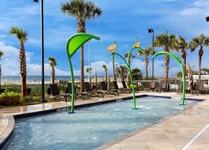 A pool area with a view of the ocean, surrounded by palm trees and lounge chairs. - Unobstructed Oceanfront View! 3BR, 3BA, Grand Atlantic Resort, 20th Floor Condo (Myrtle Beach)