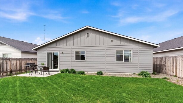 A single-story house with a covered patio, a fenced backyard, and a clear sky. - Curated Comfort in the Treasure Valley (Boise)