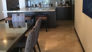 A modern kitchen with dark cabinets, a stainless steel microwave, and a granite countertop. - Posh 2-bedroom condo in charming Cabo with AC, kitchen and 2.5 baths.Ocean view. (Cabo San Lucas)