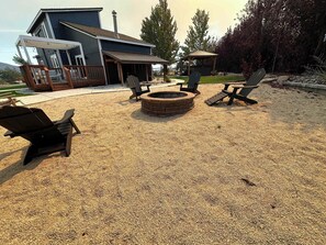 A backyard with a fire pit, outdoor seating, and a covered area. - Reno Retreat - 3BR Oasis w Swim Spa, Hot Tub (Reno)