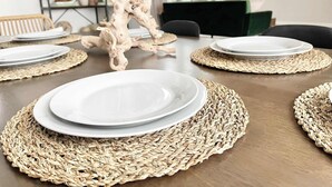 A dining table set with plates, placemats, and a decorative centerpiece. - Reno Retreat - 3BR Oasis w Swim Spa, Hot Tub (Reno)