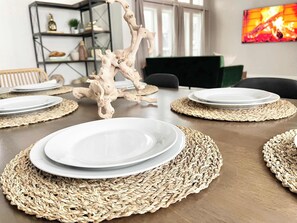 A dining table set with plates, placemats, and a decorative centerpiece. - Reno Retreat - 3BR Oasis w Swim Spa, Hot Tub (Reno)