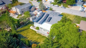 An aerial view of a residential area with houses, a driveway, and a large green space. - Modern Getaway for 11- Hot Tub, Games, Gym (Reno)