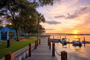 A waterfront park with a wooden boardwalk, playground, and a sunset view. - Fort Walton 3BR | 2 Kings + Fenced Yard | Pets OK (Fort Walton Beach)
