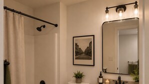 A bathroom with a bathtub, toilet, sink, and a shower curtain. - The Washington Lofts (Ellicottville)