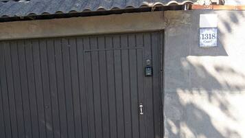 A closed garage door with a metal roof structure above it.
