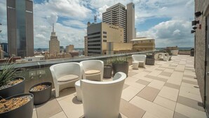 A rooftop terrace with outdoor seating, potted plants, and a city skyline view. - Top-Floor Downtown Penthouse - Terrace - 2,500 Sq - Gym+Pool+Dedicated Workplace (Dallas)
