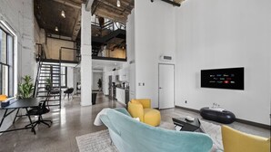 A modern interior with a sofa, a dining area, and a kitchen. - Top-Floor Downtown Penthouse - Terrace - 2,500 Sq - Gym+Pool+Dedicated Workplace (Dallas)