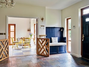 A room with a checkered floor, a wooden gate, a bench with a cushion, and a door with a window. - Luxury Exmouth Beach House for 8 (Exmouth)