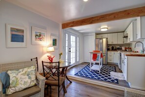 A modern kitchen with white cabinets, a stainless steel refrigerator, and a microwave. - Breezy, Bright 1 Bedroom Apartment 3 Blocks to Ledbetter Beach and Harbor (Santa Barbara)