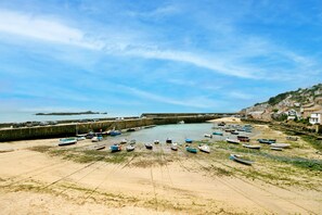 A coastal town with a sandy beach, a harbor with boats, and a stone wall. - Grand Devon Country House for 15 (Penzance)