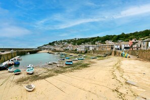 A coastal town with a sandy beach, boats, and houses along the shore. - Grand Devon Country House for 15 (Penzance)