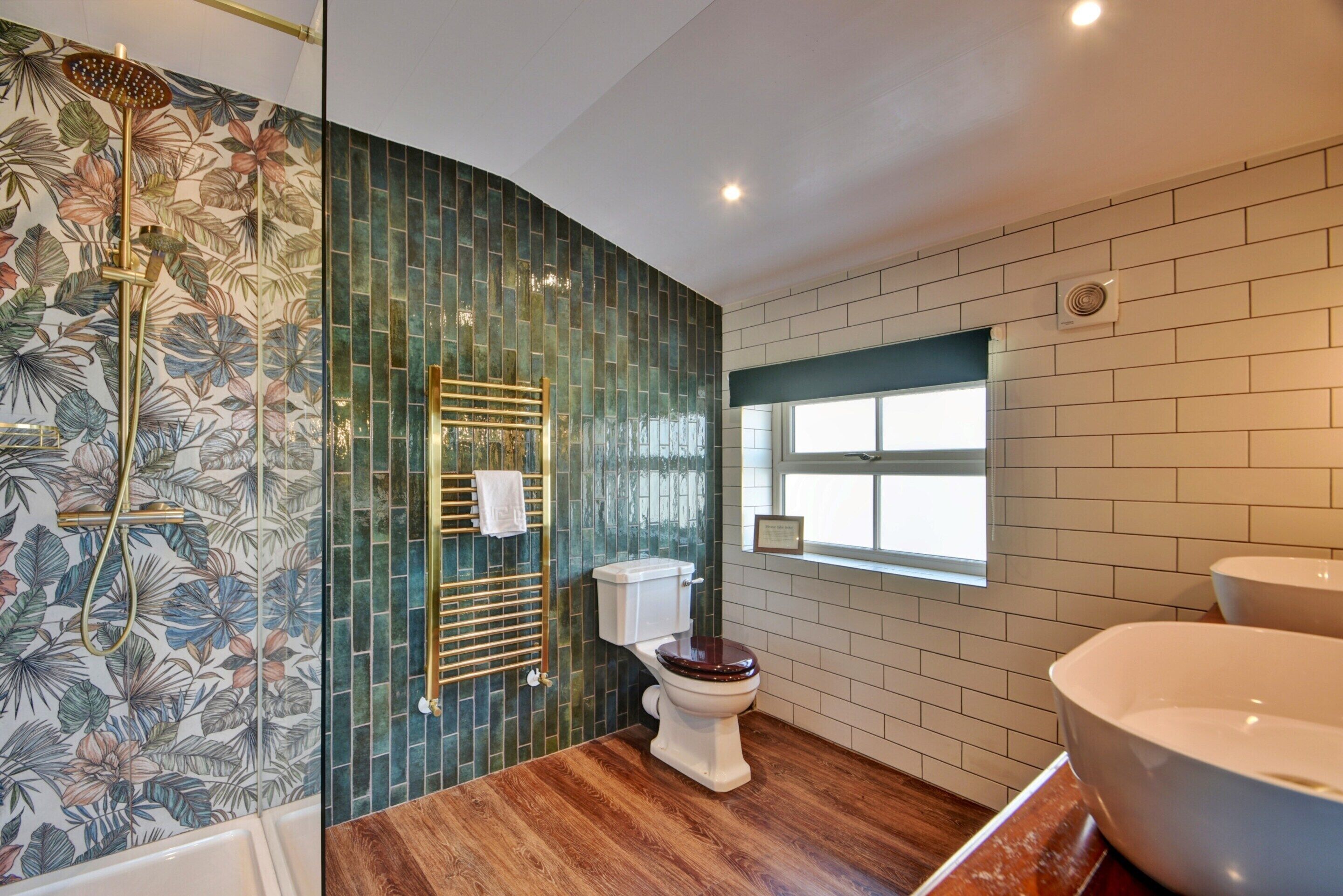 A bathroom with a shower, toilet, and bathtub.