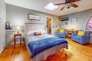A bedroom with a bed, a chair, a table, and a ceiling fan. - Del's Cabin: River Retreat Sleeps 8 w/ Hot Tub (Augusta)