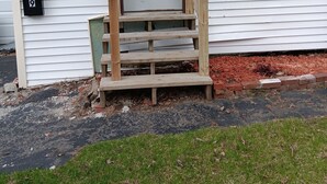 A house with a front door, a wooden staircase, and a mailbox. - Newly renovated, New England 3-bedroom home in Skowhegan. (Skowhegan)