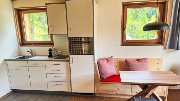 A compact kitchen with a sink, cabinets, and a window. - Arvenstudio by Interhome (La Punt-Chamues-ch)