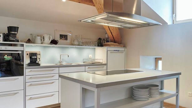 A modern kitchen with a central island, built-in appliances, and a skylight. - Palazzo Appartement/Fewo, Dusche, WC, 3 Schlafräume by Interhome (Bivio)