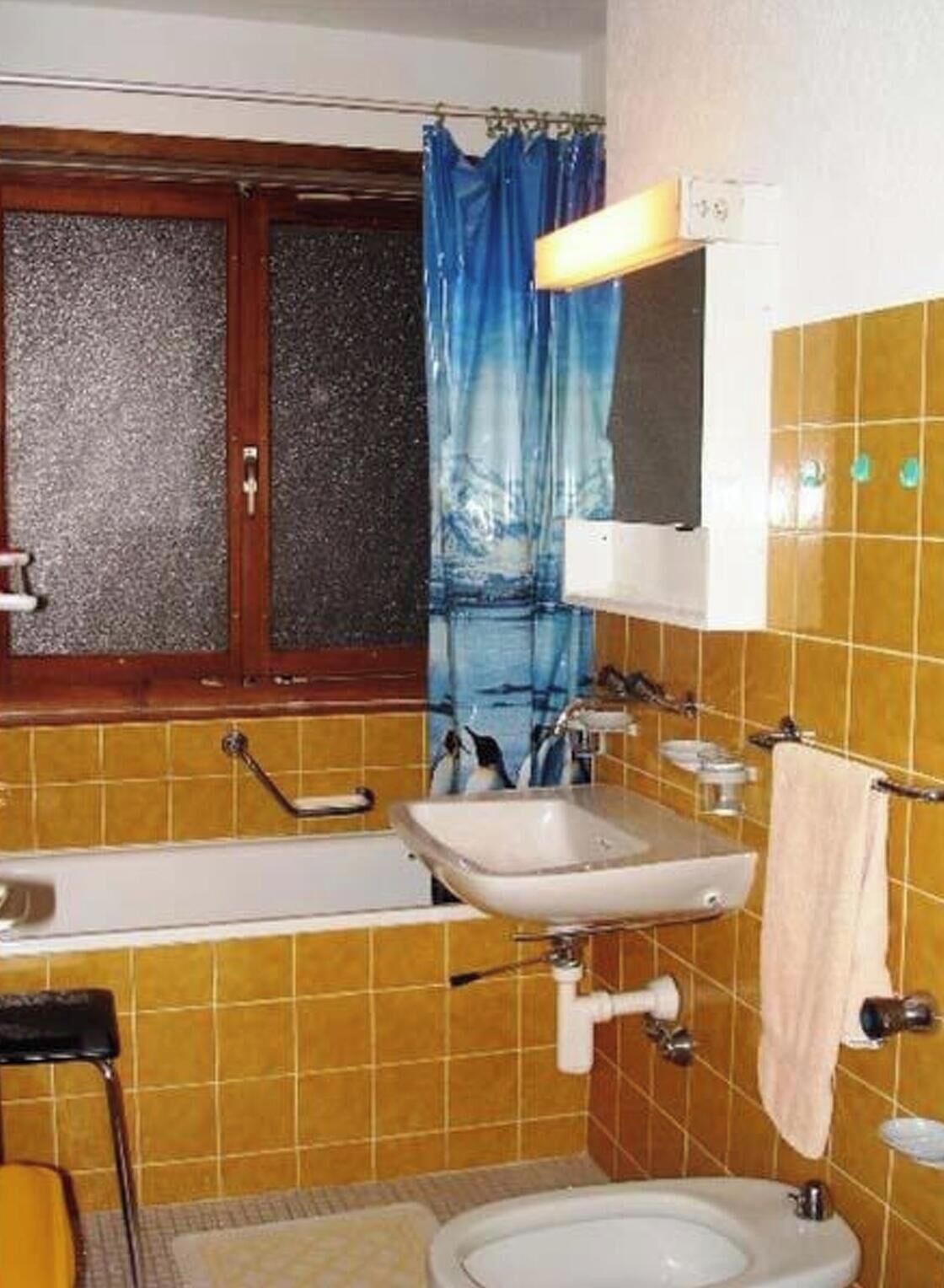 A bathroom with a bathtub, sink, and toilet.