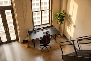 A room with a desk, chair, and a potted plant. - Penthouse Loft, Central Downtown Dallas, Pool+Gym+Office, City Views (Dallas)