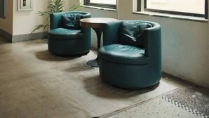 A modern interior with two round teal chairs, a small table, and large windows allowing natural light. - Penthouse Loft, Central Downtown Dallas, Pool+Gym+Office, City Views (Dallas)