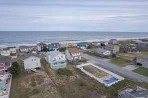 A coastal residential area with houses, a swimming pool, and a beach in the background. - 4755 - The OBX Rx, Semi-oceanfront! (Kitty Hawk)