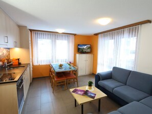 A compact living space with a kitchenette, dining area, and seating area. - GOLF Apartments Appartement/Fewo 6-Bettwohnung Nr. 1 by Interhome (Saas-Fee)