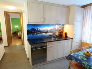 A compact kitchen with a built-in stove, oven, and sink. - GOLF Apartments Appartement/Fewo 6-Bettwohnung Nr. 1 by Interhome (Saas-Fee)