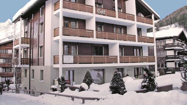 A multi-story hotel with balconies, a sign indicating it's a golf resort, and snow-covered surroundings. - GOLF Apartments Appartement/Fewo 4-Bettwohnung Nr. 3 by Interhome (Saas-Fee)