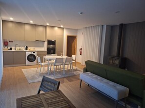 A modern apartment with a kitchen, dining area, and living space. - House 1 (Esposende)