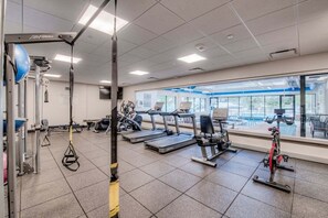 A gym with exercise equipment, a large window, and a view of the outdoors. - Peak 9 Inn 4512: Stellar Views - Downtown & Ski In Ski Out @ Base of Peak 9 (Breckenridge)