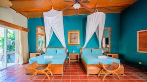 A room with two beds, a ceiling fan, and a window with curtains. - Waves Sunzal (Tamanique)