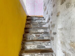 A stone staircase with a yellow wall on one side. - Baita Melissa by Interhome (Vercana)