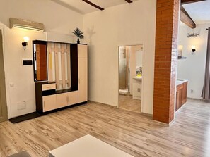 A modern interior with a kitchen area, a dining space, and a visible bathroom. - Celeste Prague (Hlavní město Praha)