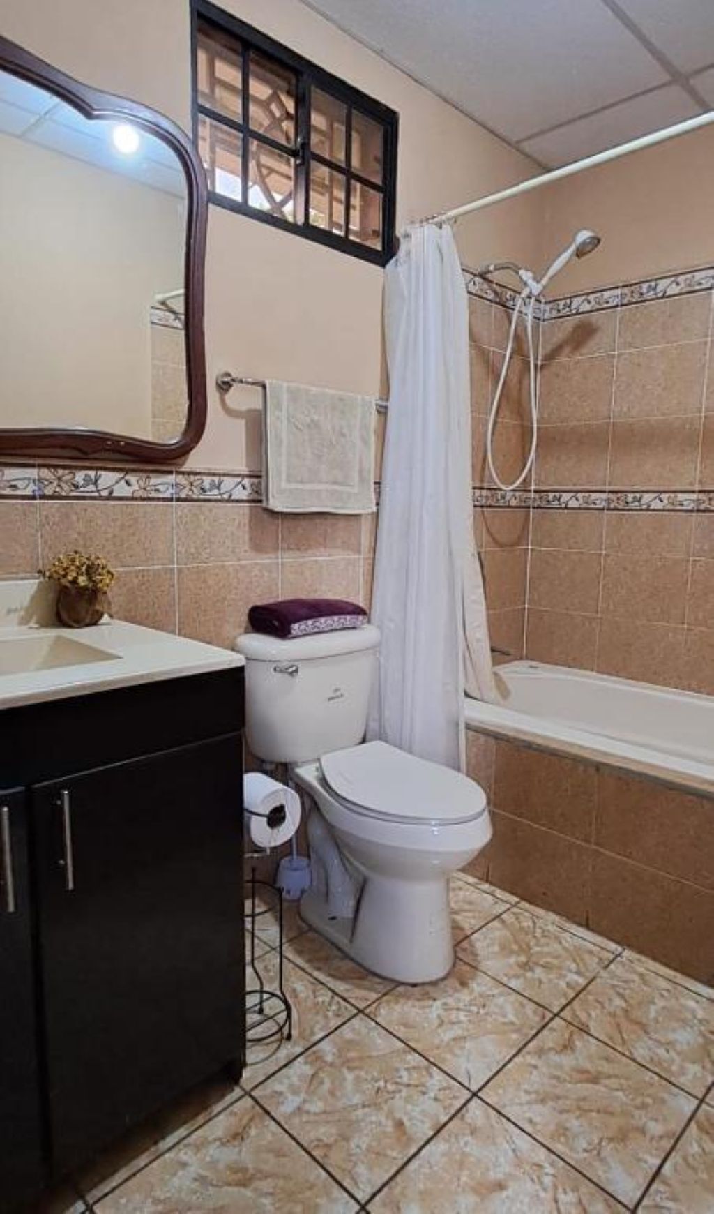A bathroom with a toilet, sink, and bathtub.