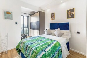 A bedroom with a bed, a window, and a balcony. - Urban Oasis (Nairobi)