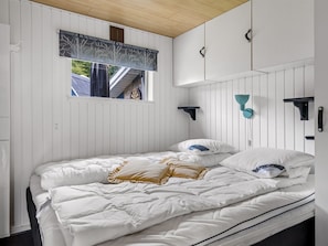 A bedroom with a bed, pillows, a window with a view, and a ceiling with wooden beams. - "Agla" - 350m from the sea by Interhome (Aabenraa)
