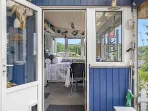 A cozy bedroom with a bed, a chair, and a window overlooking greenery. - "Agla" - 350m from the sea by Interhome (Aabenraa)