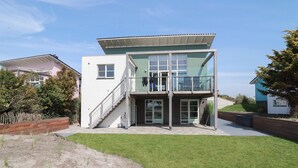 A modern two-story building with a flat roof, large windows, and a covered entrance area. - Luxury Makkum Beachvilla for 6 (Makkum)