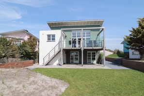 A modern two-story building with a flat roof, large windows, and a covered entrance area. - Luxury Makkum Beachvilla for 6 (Makkum)