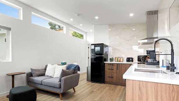 A modern kitchen with a built-in refrigerator, a coffee maker, and a sink. - Spacious w/1BR 1Bath - Near DTLA (Los Angeles)