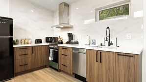 A modern kitchen with a built-in oven, microwave, and coffee maker. - Spacious w/1BR 1Bath - Near DTLA (Los Angeles)