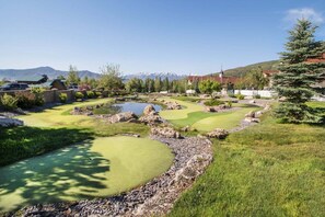 A golf course with multiple holes, a pond, and a mountainous backdrop. - Villa 2080 1 Bed 1 Bath Full Kitchen in the heart of Midway Utah (Midway)
